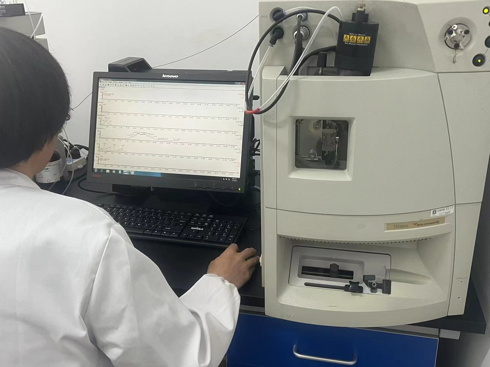 Laboratory operator using an analytical instrument in supplied project materials